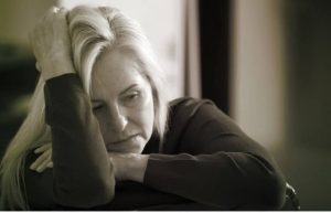 Gray and white photo of a depressed woman in perimenopause